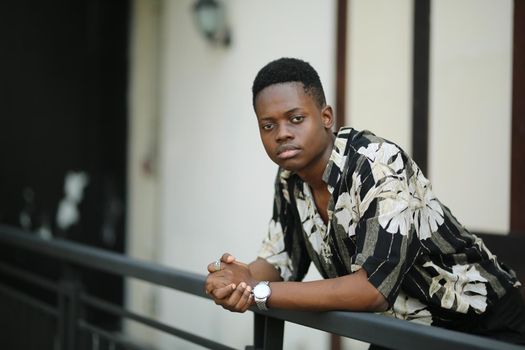 Portrait of young handsome afro black man posing outdoor.