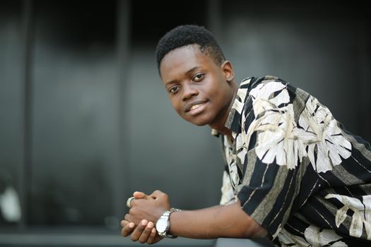 Portrait of young handsome afro black man posing outdoor.