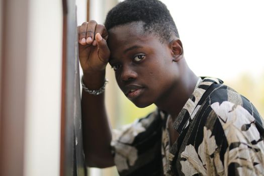 Portrait of young handsome afro black man posing outdoor.