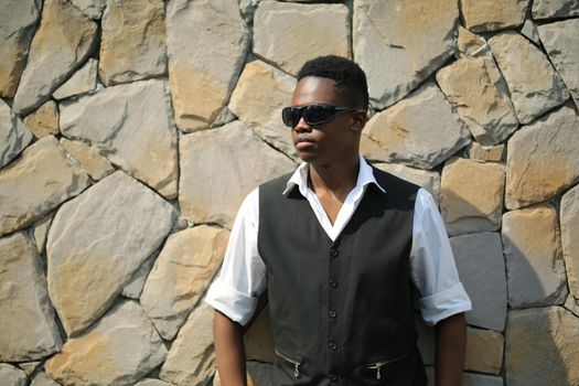 Portrait of young handsome afro black man posing outdoor.