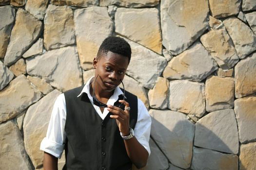 Portrait of young handsome afro black man posing outdoor.