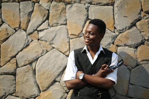 Portrait of young handsome afro black man posing outdoor.