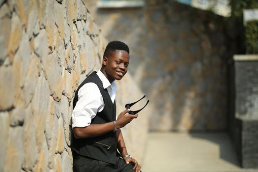 Portrait of young handsome afro black man posing outdoor.