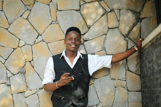 Portrait of young handsome afro black man posing outdoor.