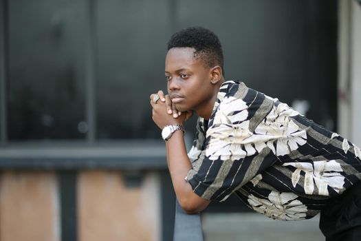 Portrait of young handsome afro black man posing outdoor.