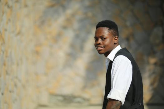 Portrait of young handsome afro black man posing outdoor.