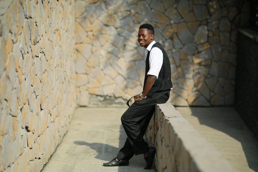 Portrait of young handsome afro black man posing outdoor.