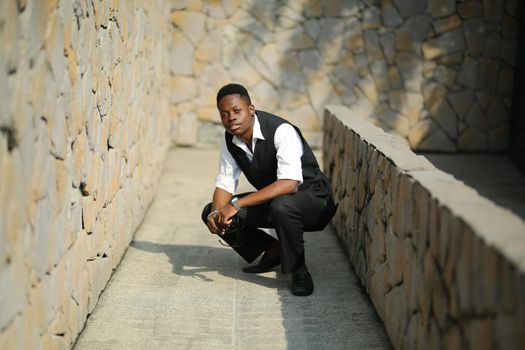 Portrait of young handsome afro black man posing outdoor.