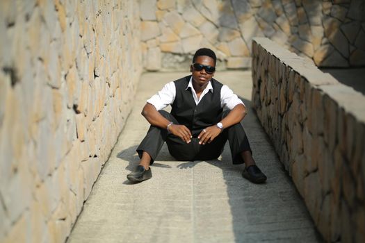 Portrait of young handsome afro black man posing outdoor.