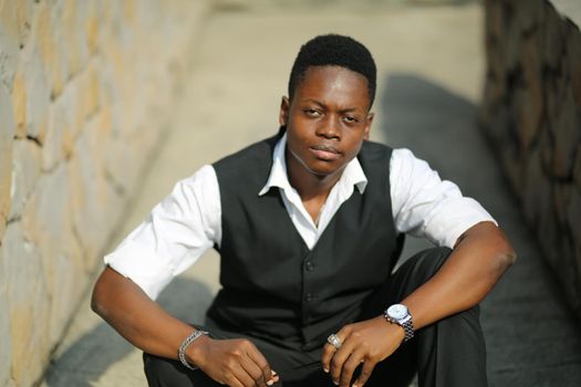 Portrait of young handsome afro black man posing outdoor.