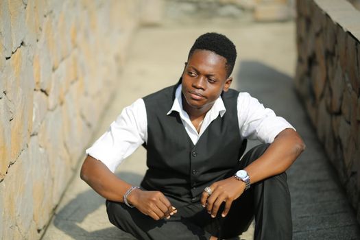 Portrait of young handsome afro black man posing outdoor.