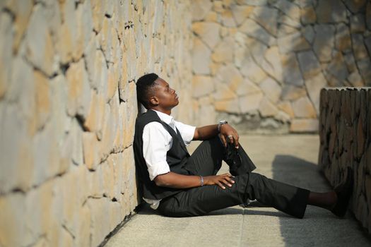 Portrait of young handsome afro black man posing outdoor.