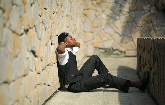 Portrait of young handsome afro black man posing outdoor.