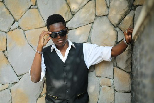 Portrait of young handsome afro black man posing outdoor.