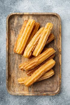 Churros with chocolate, Traditional Spanish cusine, on gray background, top view flat lay