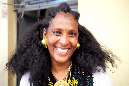 Adigrat, Ethiopia - 6 June 2019 : Ethiopian Irob woman in traditional dress, with gold earings and necklace.