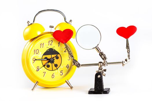 .Abstract Valentines Day background with engineering tool third hand holding hearts and alarm clock on white background