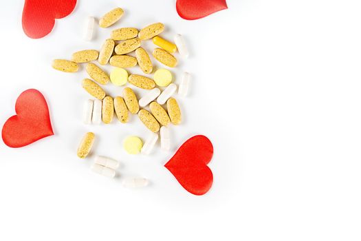 The hearts, tablets and pills isolated on white background Valentines Day or pharmaceutical background