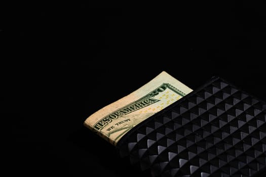 Dollars money banknotes in a black wallet isolated.