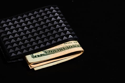 Dollars money banknotes in a black wallet isolated.