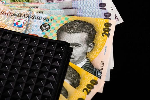 LEI romanian money banknotes in black wallet isolated