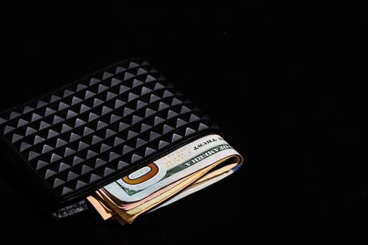 Dollars money banknotes in a black wallet isolated.