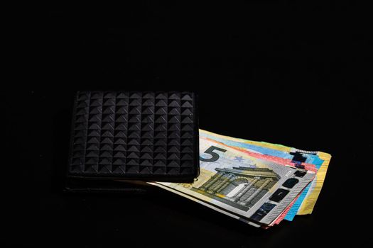 Euro banknotes in black wallet isolated.