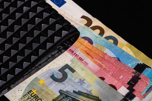 Euro banknotes in black wallet isolated.