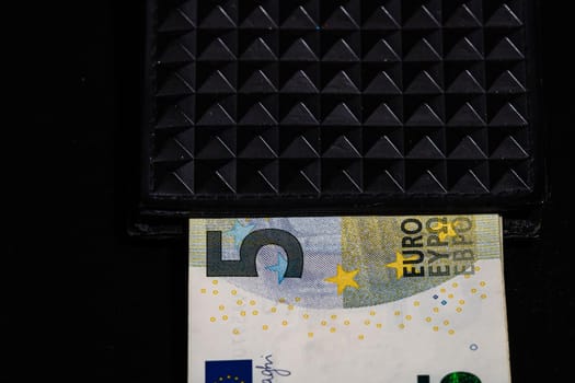 5 Euro money banknotes in black wallet isolated