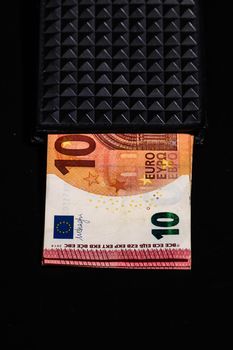 10 Euro money banknotes in blak wallet isolated