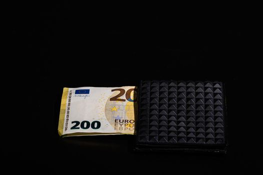 200 Euro banknotes in a black wallet isolated.