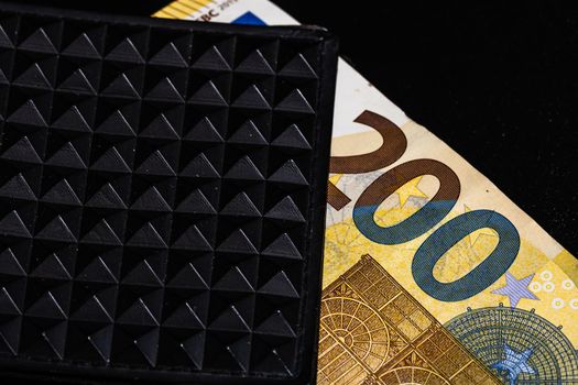 200 Euro banknotes in a black wallet isolated.