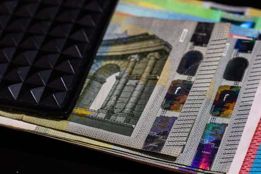 Euro banknotes in black wallet isolated.