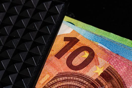 Euro banknotes in black wallet isolated.