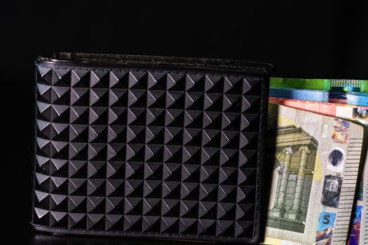 Euro banknotes in black wallet isolated.