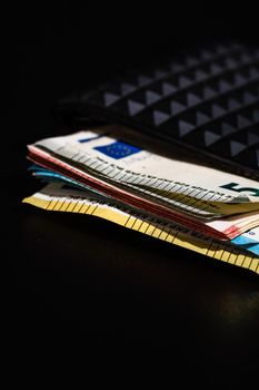 Euro banknotes in black wallet isolated.