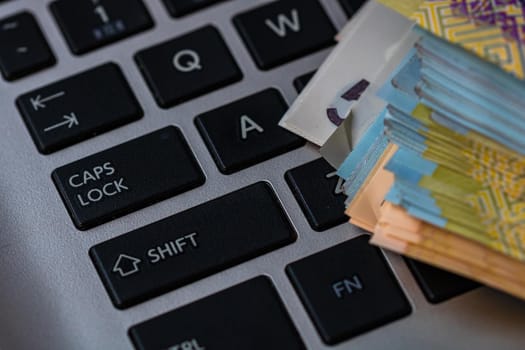 Lei banknotes on keyboard. Selective focus on stack of LEI romanian money.