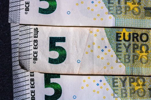 Selective focus on detail of euro banknotes. Close up macro detail of money banknotes, 5 euro isolated. World money concept, inflation and economy concept