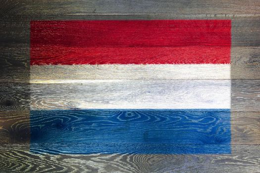 A Netherlands flag on rustic old wood surface background
