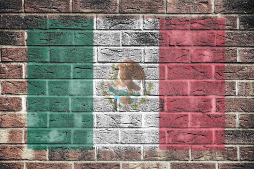 A Mexico flag on old brick wall background

