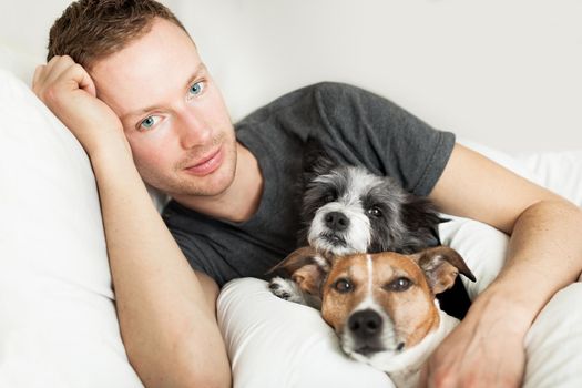dog owner in bed with two cute dogs