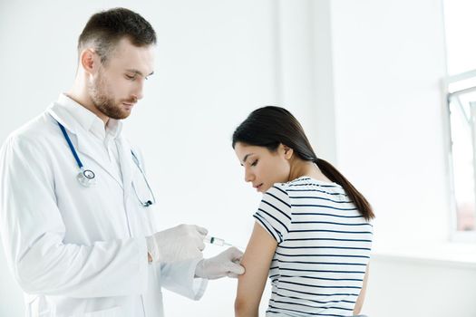 male doctor giving an injection to a patient in a hospital coronavirus. High quality photo