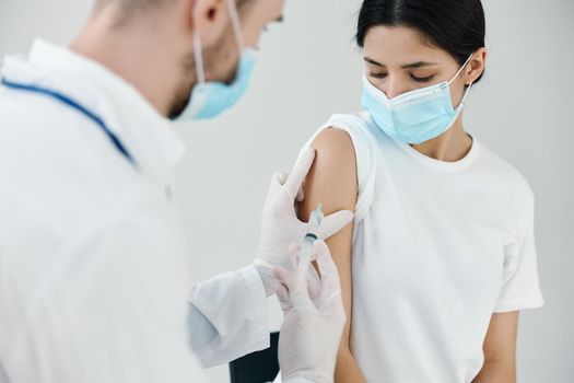 vaccination injection patient in medical mask in hospital and doctor. High quality photo