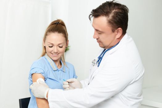 male doctor in a white coat a syringe in the hands of an injection. High quality photo