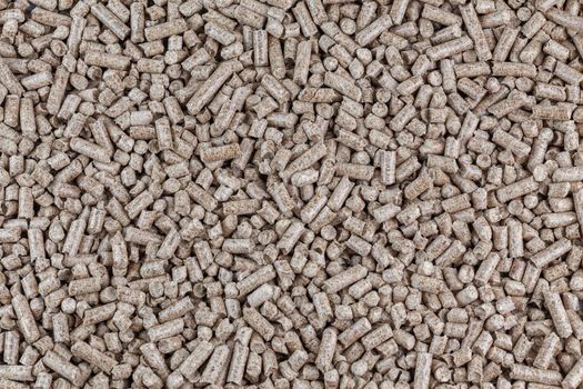 Compressed wooden sawdust pellets texture and background. Alternative biofuel and pet litter, mulch.
