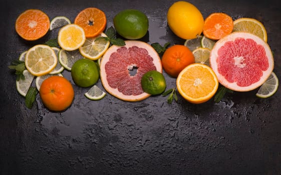 Citrus background. Fresh citrus fruits - Lemons, oranges, limes, grapefruits On wooden background