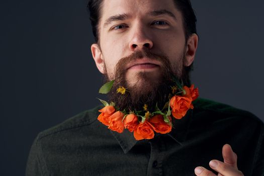 emotional man flowers in a beard gift romance decoration studio. High quality photo