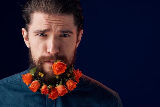 Bearded man holding flowers decoration romance luxury dark background. High quality photo