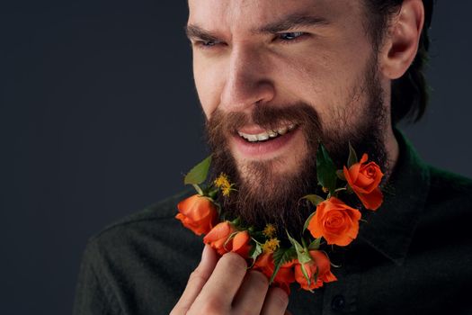 Nice man and flowers in the city decoration charm close-ups Studio. High quality photo
