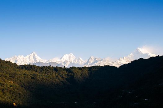 Mount Kanchenjunga range of the himalayas at first light of sunrise at Sikkim , India